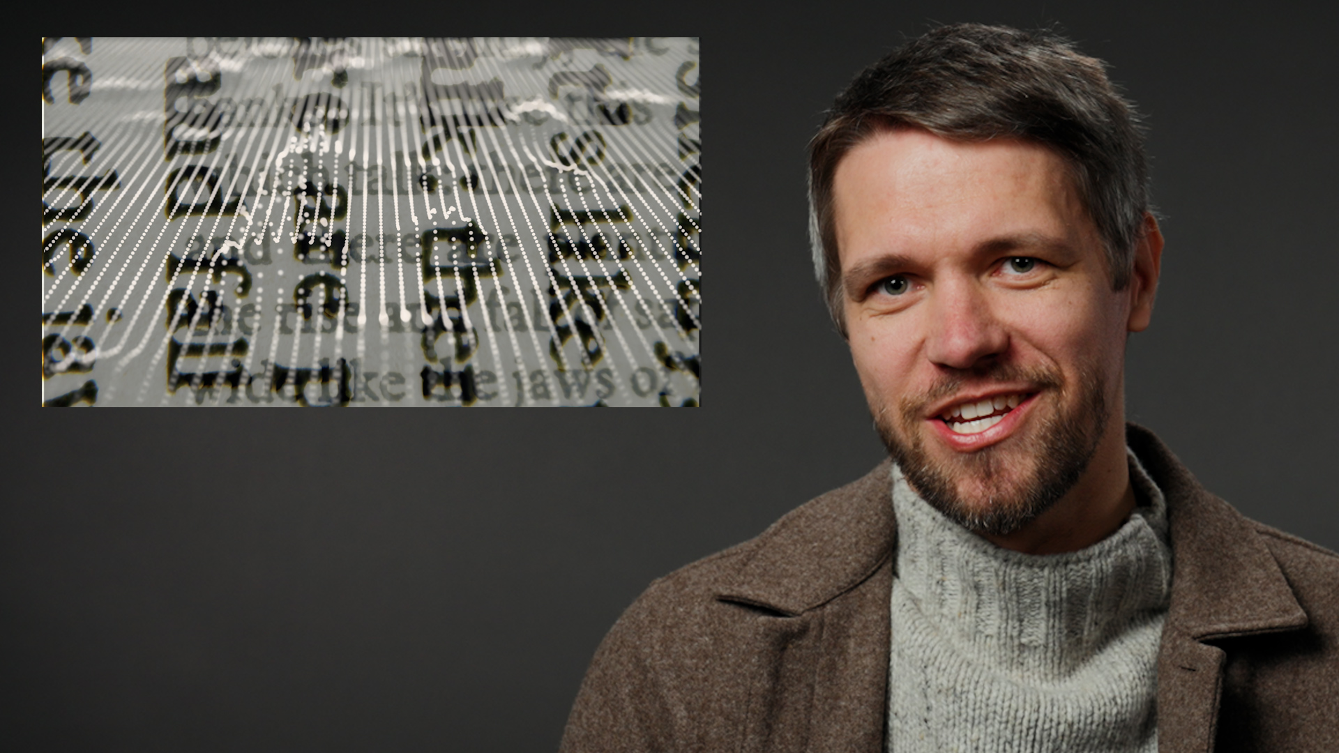 A smiling man on a gray background with an inset image of unreadable text