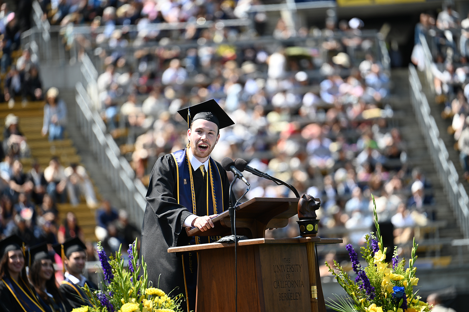 Asher Cohen, the 2025 University Medalist, stands at the podium and gives a speech at the 2025 campuswide commencement.