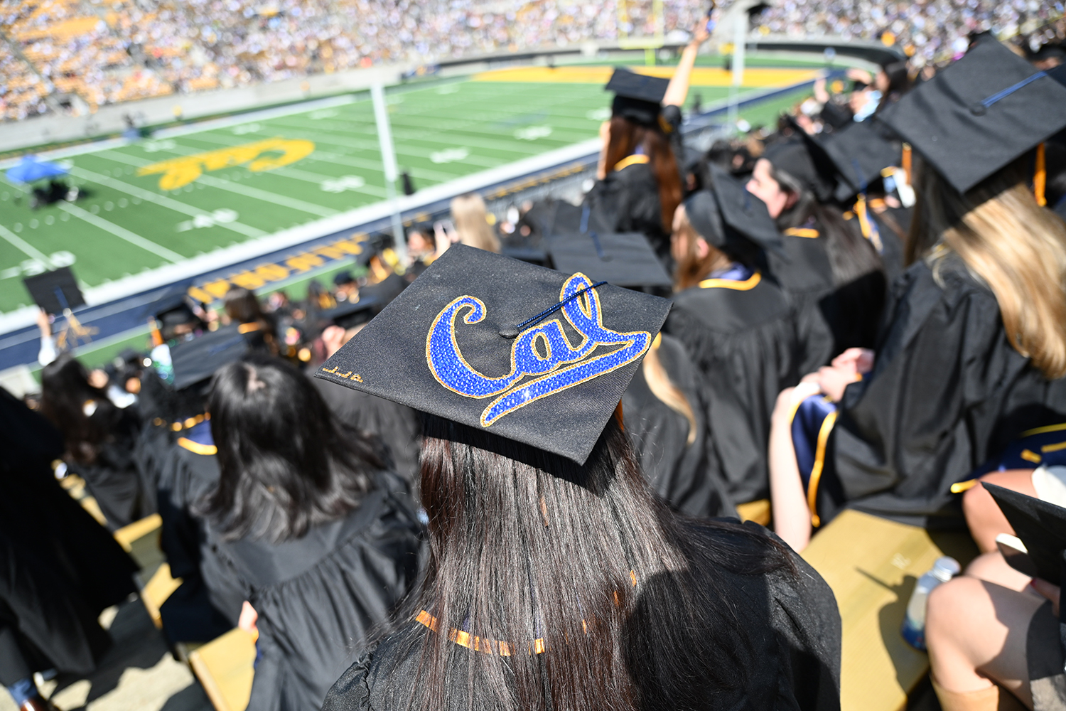 A student's mortarboard simply says Cal, in beaded blue lettering, at the 2025 campuswide commencement.