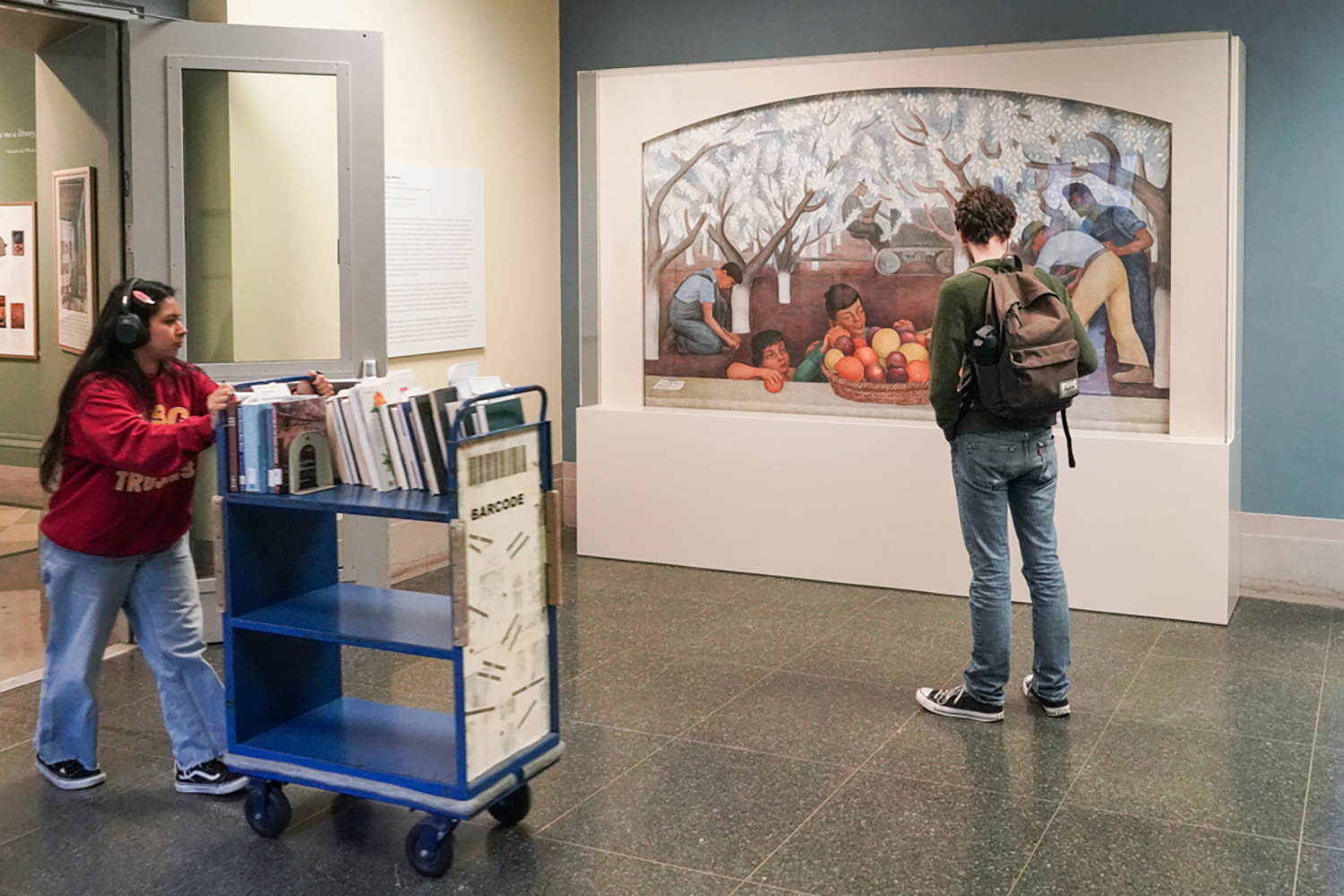 A student admires the Diego Rivera mural recently installed in Doe Library.