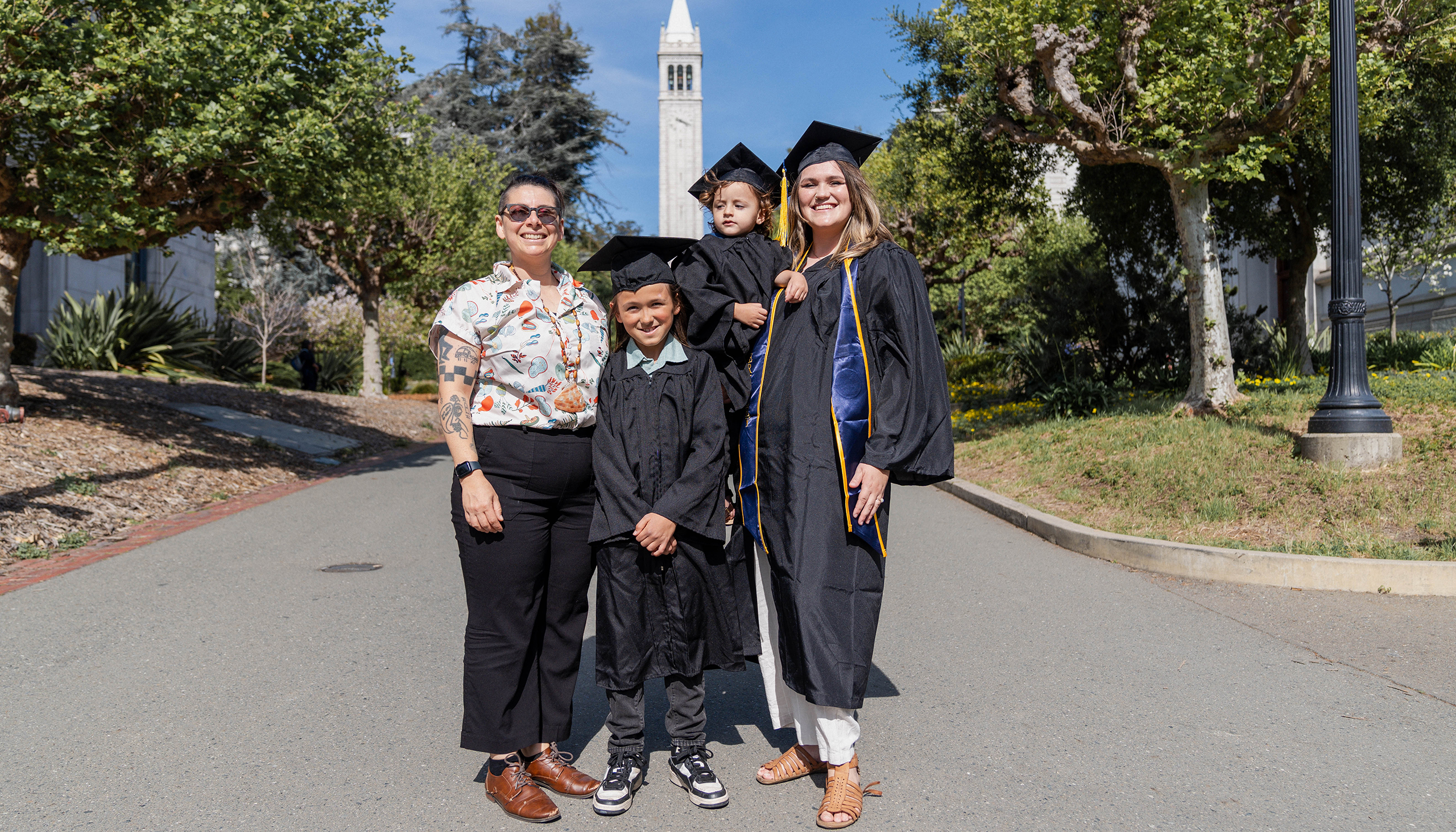 Emily stands with her wife and two kids on UC Berkeley campus, showing how close they are as a family