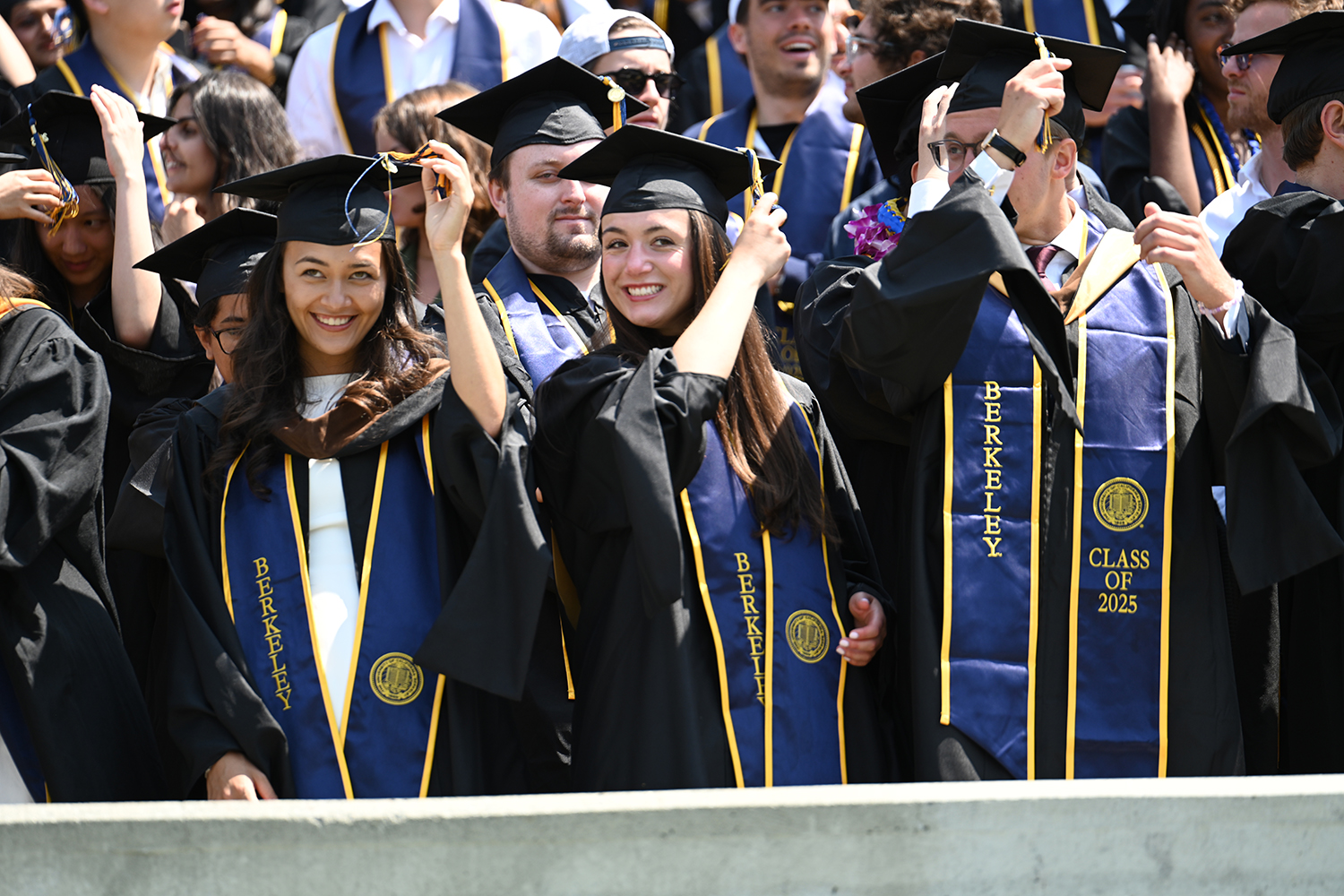 Graduates flip their tassels to the left at the 2025 campuswide commencement, symbolizes the transition from student to graduate.