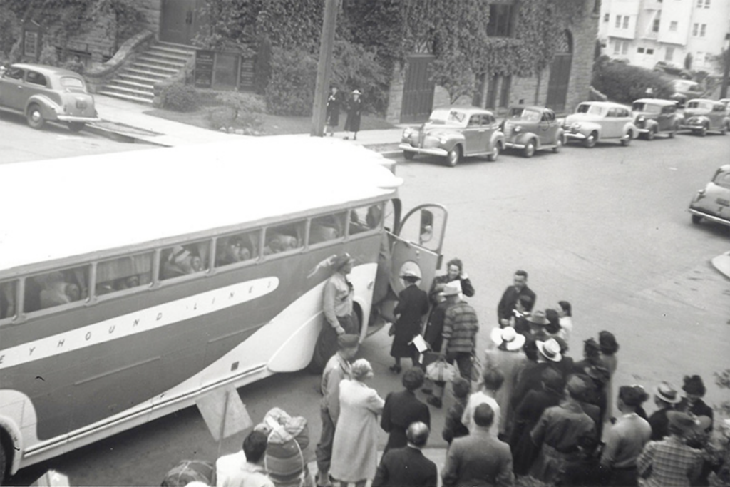 This black and white photo from 1942 shows Japanese Americans in Berkeley boarding a bus for an internment camp.