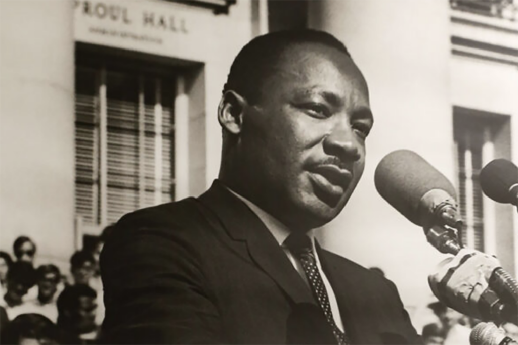 Dr. Martin Luther King Jr. speaks at a microphone on the steps of Sproul Plaza in May 1967.