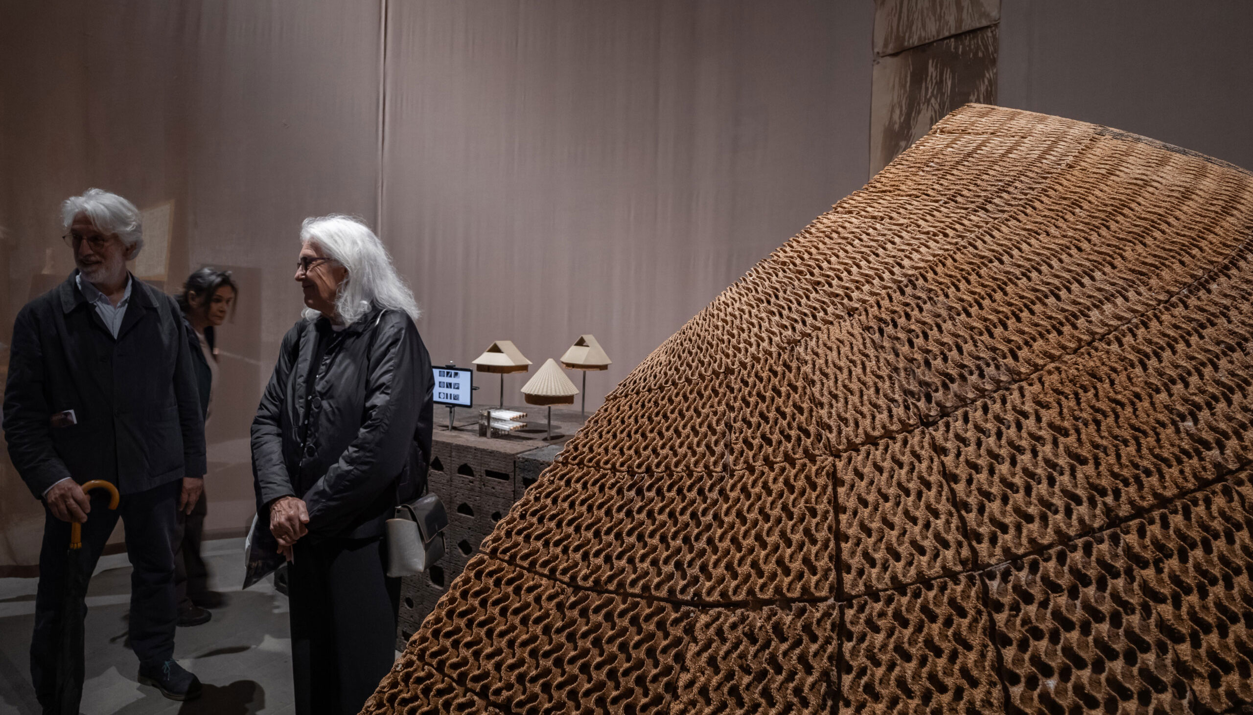 Maria Paz Gutierrez standing next to a structure that looks like corrugated cardboard.