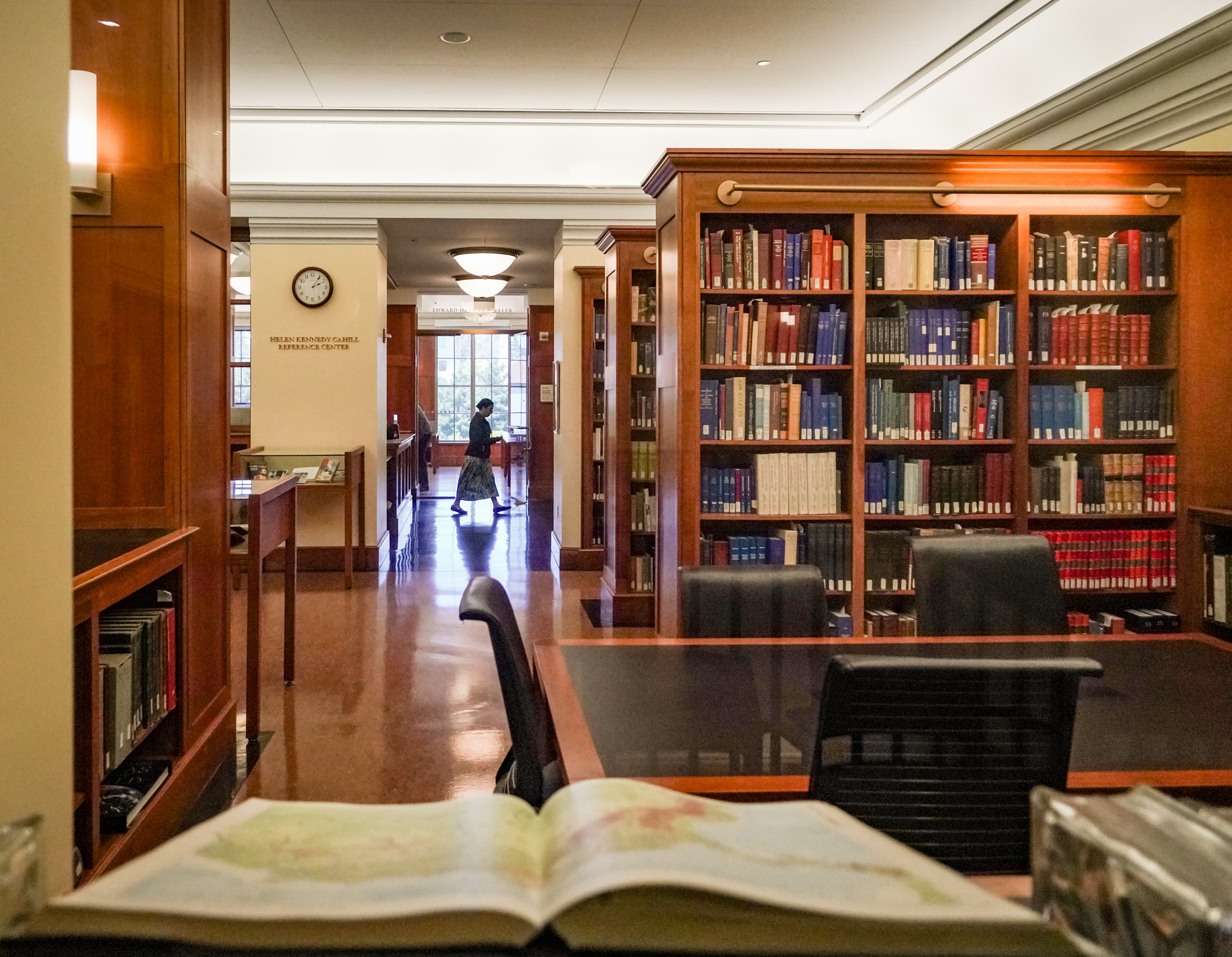 People visit the Reading Room in The Bancroft Library, with shelves of books lining the halls.