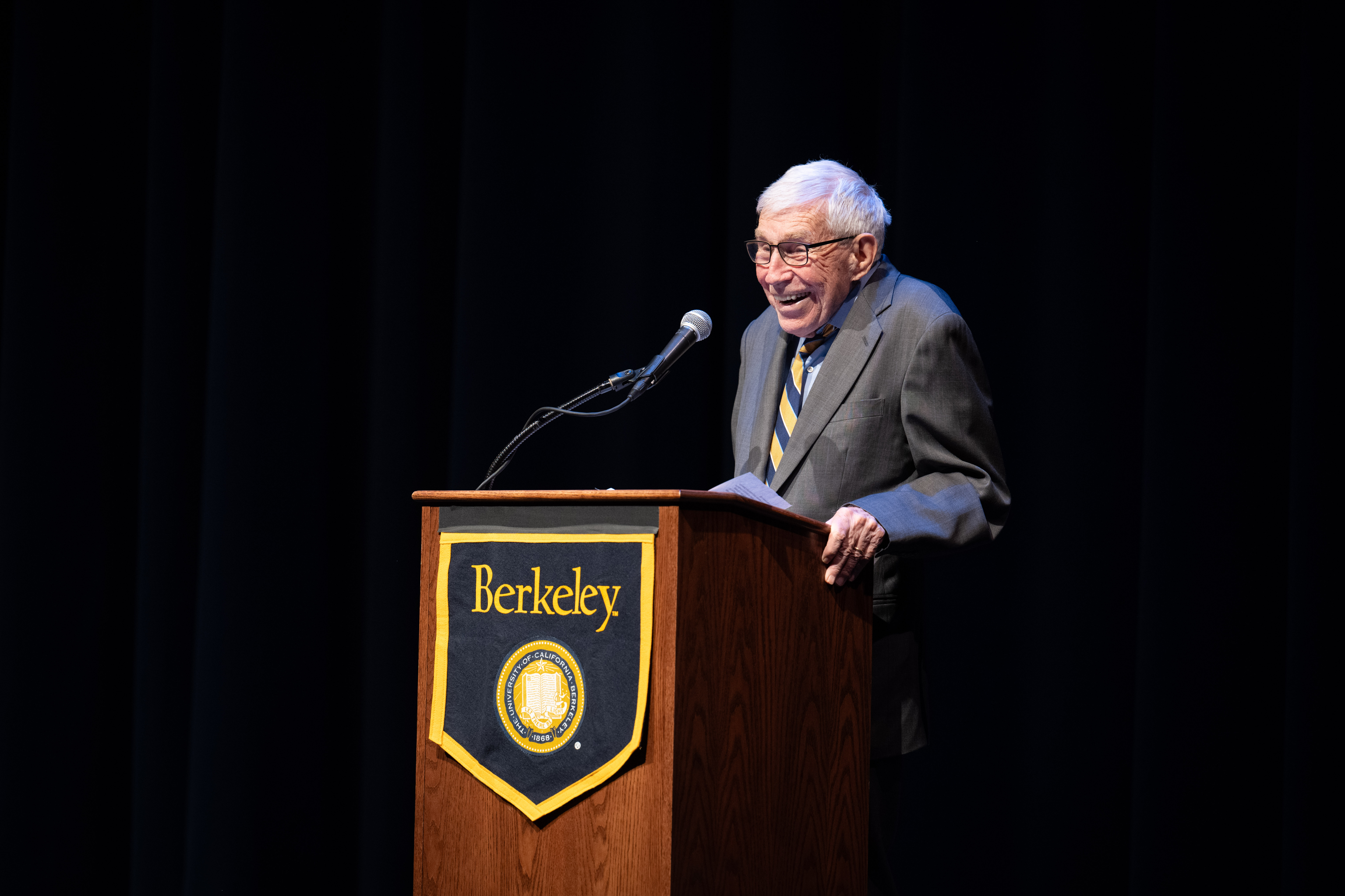 Frank Baxter stands at a UC Berkeley podium.