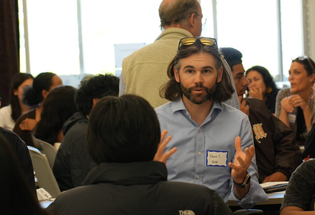 Devin Corrigan speaking in a group
