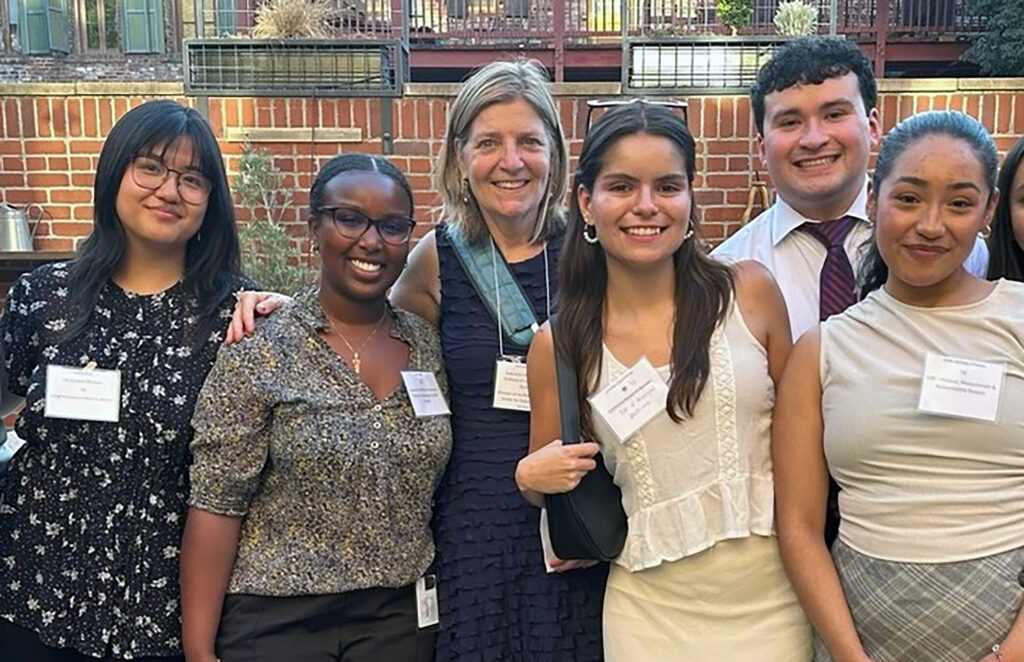 A group photo with Christine Trost at the center, surrounded by five 2024 Cal-in-Sacramento fellows.