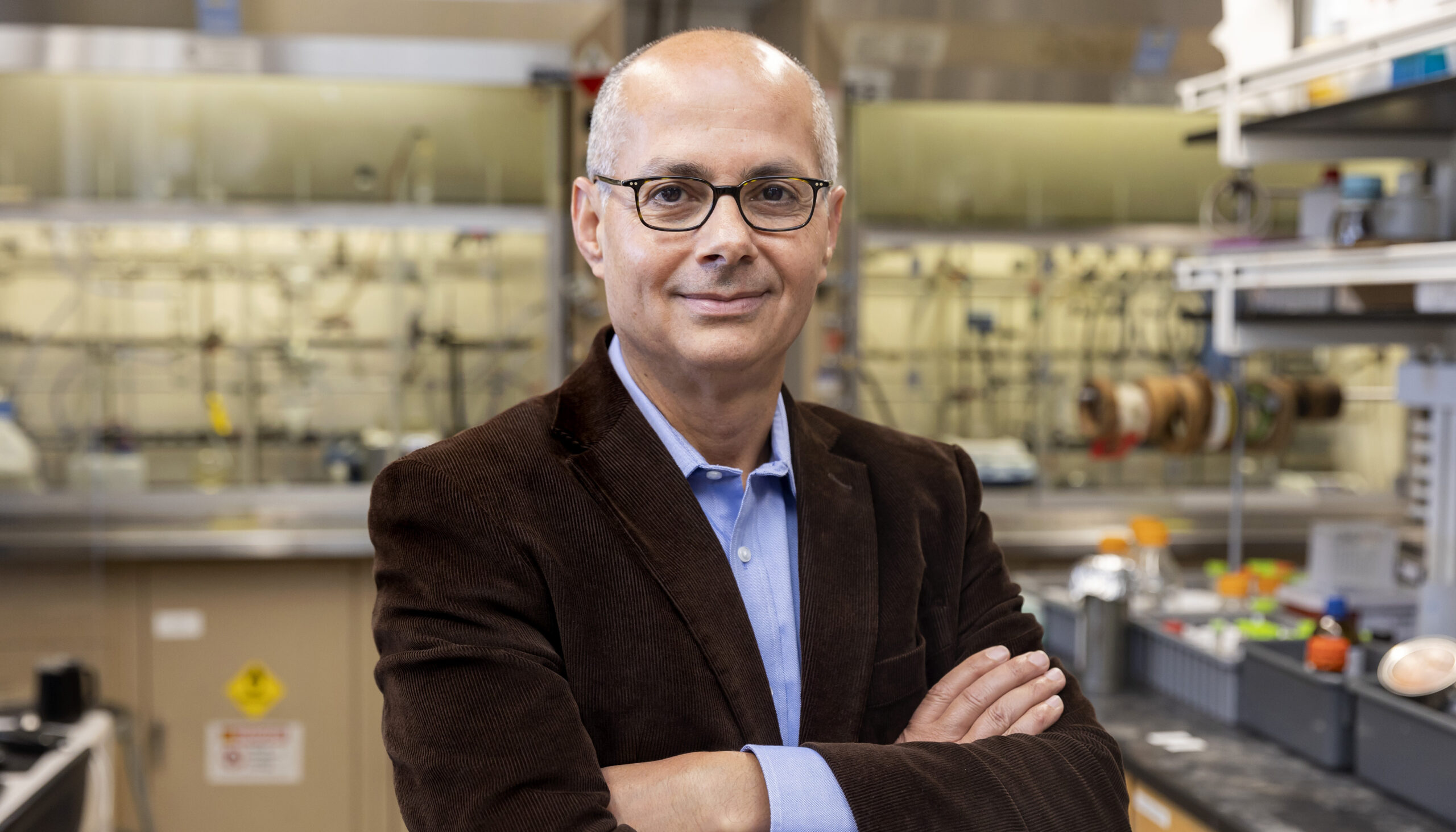 man with arms folded in a lab