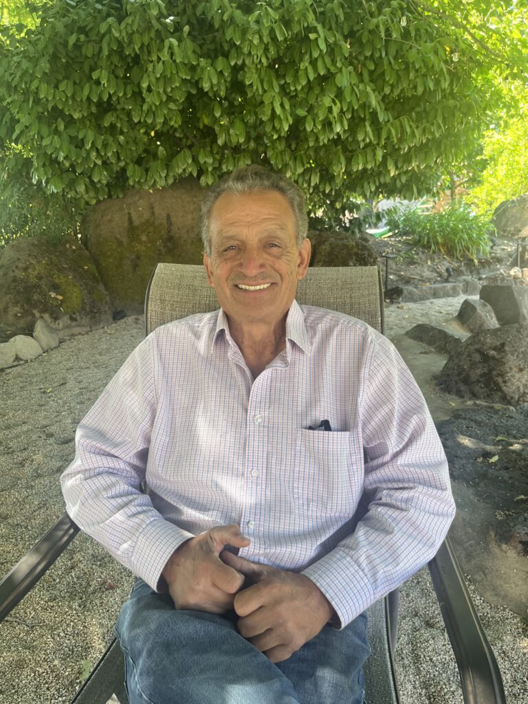 Zeke Guzman sitting in a chair outdoors