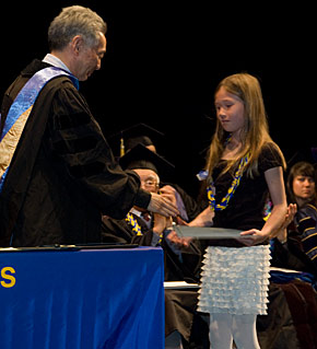 girl accepting diploma on behalf of grandmother