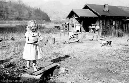 A young girl fingerpainting outside her Appalachian home