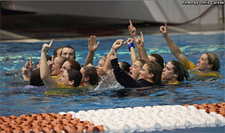 Women's team celebrates their victory with a dip in the pool