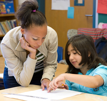 Student tutoring an elementary school child.