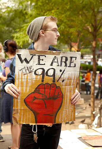 Young protestor with sign: "We are the 99%"