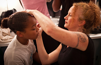 Amy Cranch helps young dancer with makeup